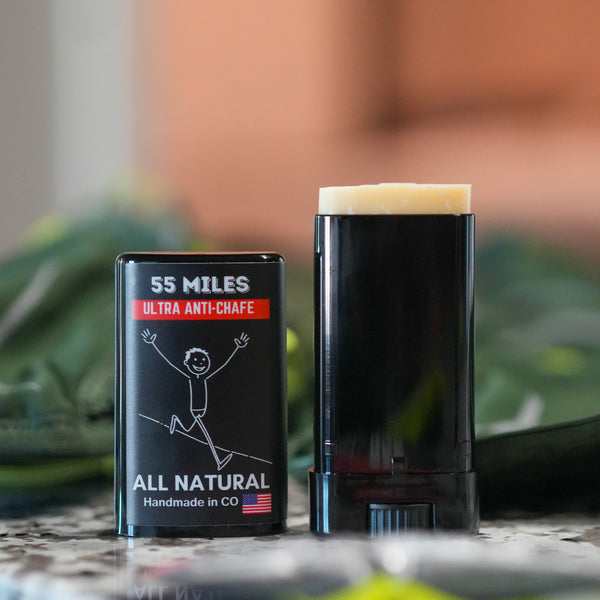 55 Miles ultra anti-chafe stick and packaging on a blurred natural background